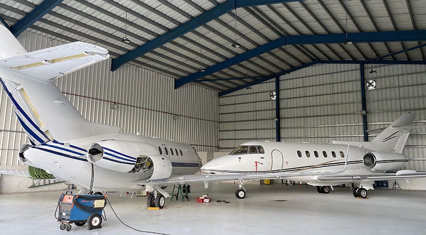 Two aircraft inside a hangar